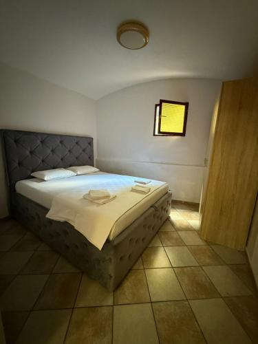 a bedroom with a bed in a room with a window at Casa Di Porto in Kotor