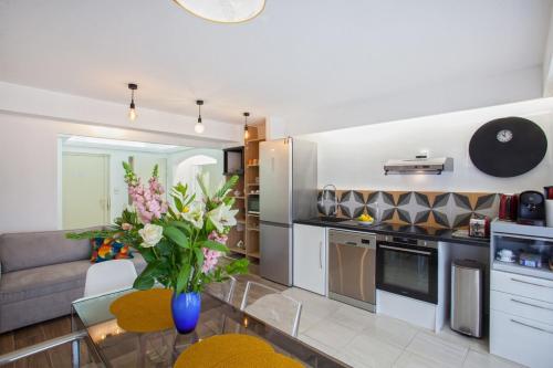 a kitchen and living room with a couch and a table at Lucamare - Casa Rossa in LʼÎle-Rousse