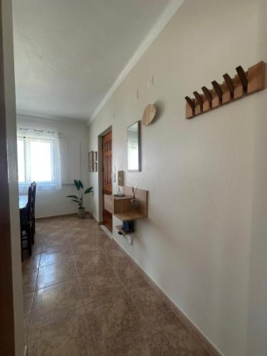 a room with a sink and a mirror on a wall at Charm-In Apartments in Vila Nova de Milfontes