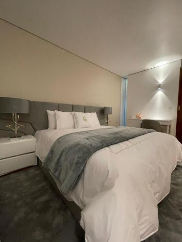 a bedroom with a large white bed in it at Green Gold Passion in Santo Estêvão