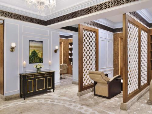 a lobby with a chair and a table at Raffles Udaipur in Udaipur