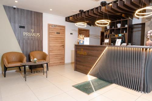 a restaurant with a table and chairs and a counter at Primus Hotel & Apartments in Vienna