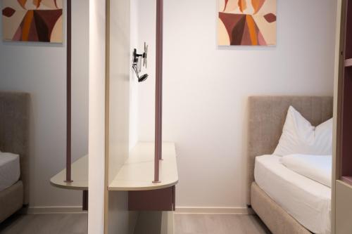 a living room with a couch and a mirror at Primus Hotel & Apartments in Vienna