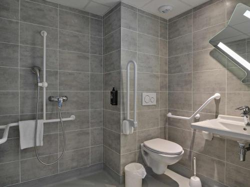 a bathroom with a shower and a toilet and a sink at Ibis Budget Nangy Annemasse in Nangy
