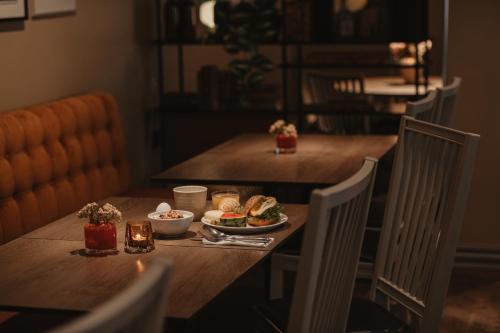 a table with a plate of food on it at Home Hotel Bergmästaren in Falun