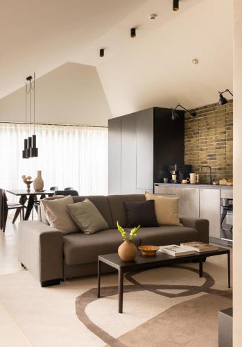 a living room with a couch and a table at The Hamlet - Luxury Serviced Apartments in Geneva