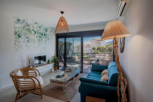 un soggiorno con un divano blu e un tavolo di Playa Marina a Bastia