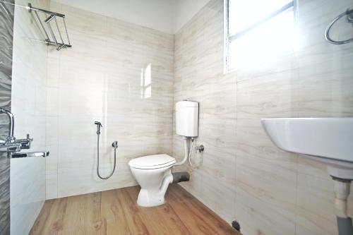 a bathroom with a toilet and a sink at Vortex homes in Guwahati
