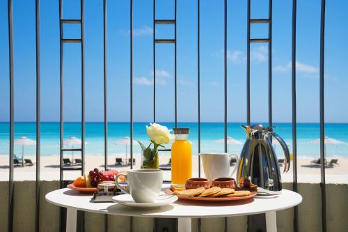 a table with breakfast food and a view of the beach at Al Alamein Hotel in El Alamein