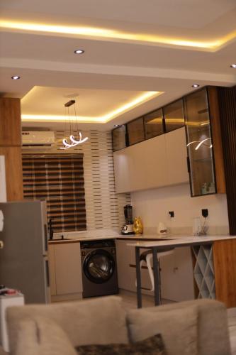 a kitchen with a table and a washer at Oasis Beautiful 2 Bedroom Shortlet Apartment in Lekki