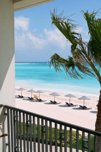 a view of a beach with umbrellas and the ocean at Al Alamein Hotel in El Alamein