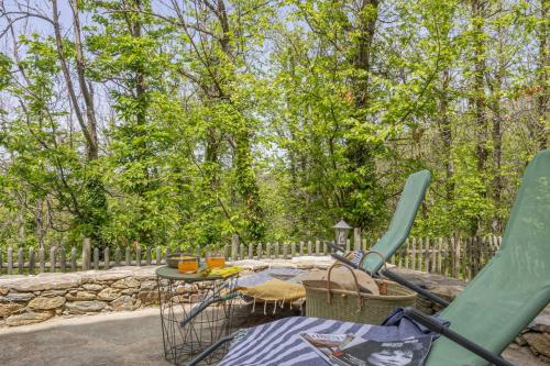 a patio with a table and chairs and a slide at Casa U Castagnettu 2 in Patrimonio