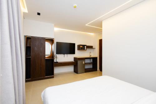 a hotel room with a bed and a television at Imperial Luxury Hotel in Cairo