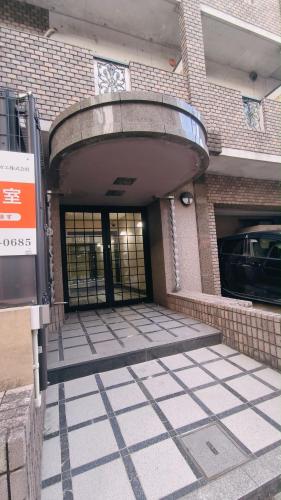an entrance to a building with a revolving door at Sea Bloom Hotel in Dejimamachi