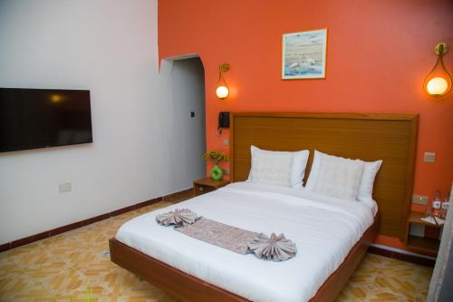 Katil atau katil-katil dalam bilik di Whispering Palms Gardens, Hotel and Suites