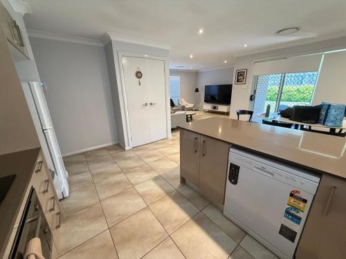 a kitchen and living room with a counter top at The Glorious Hideaway Welcome to your home in Schofields