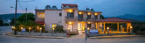 a large house with lights in front of it at Villa Ikaros in Ammoudia