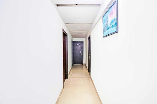a hallway of a house with white walls at Hotel O Prabhat Nagar Bareilly in Bareilly