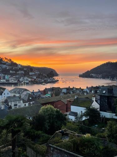 a view of a city with a sunset at Admiral's Quarters - Stunning river and sea views in Dartmouth