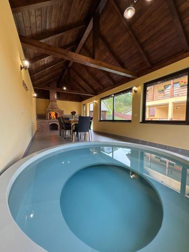 a large swimming pool in the middle of a house at Casa Abrudan in Scrind-Frăsinet
