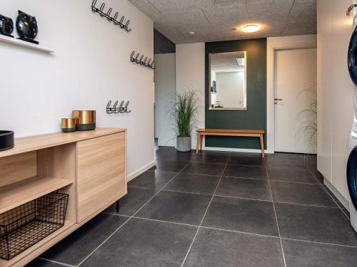 a hallway with a tile floor in a room at 14 person holiday home in Glesborg in Glesborg