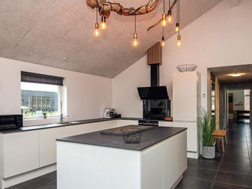 a kitchen with a large island in a room at 14 person holiday home in Glesborg in Glesborg