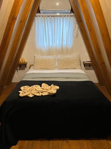 a bed in a small room with a window at ALPINAS DeL MONTE in Cortaderas