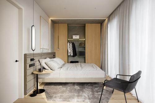 a bedroom with a bed and a chair in it at Novotel Tallinn in Tallinn