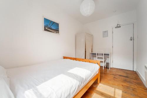 a bedroom with a large white bed in a room at Georgian Shared House No'64 - By Clifton Short Lets in Bristol