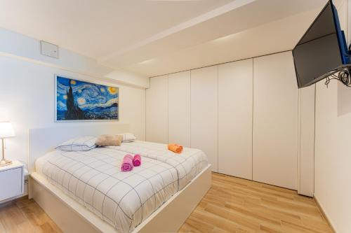 a bedroom with a bed with pink shoes on it at Flex SelfCheckIns 146 - Zagreb - 1 Bedroom - Loggia - WIFI in Zagreb