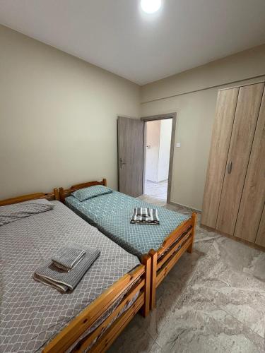 a bedroom with a bed with tongs on it at Bungalow By Eftimiya in Nea Roda