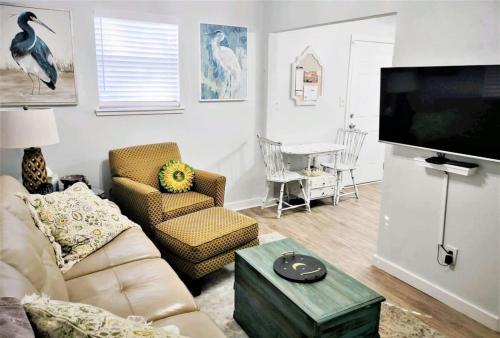 a living room with a couch and a flat screen tv at COZY-Quiet Cottage Pets Kitchen in Tallahassee