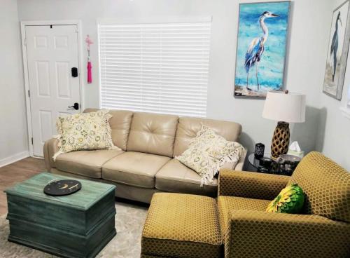 a living room with a couch and two chairs at COZY-Quiet Cottage Pets Kitchen in Tallahassee