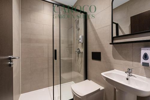 a bathroom with a shower and a toilet and a sink at Westciti Caroco Aparthotel in Croydon
