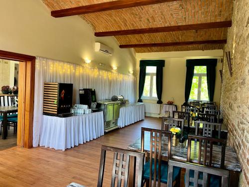 a large room with tables and chairs and a room with a room at Amálka u Řípu in Straškov