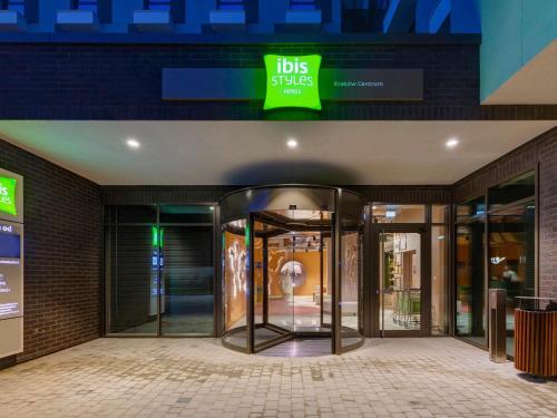 a store front with revolving doors in a building at ibis Styles Kraków Centrum in Kraków