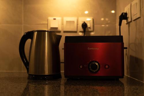 a toaster and a coffee pot sitting on a counter at Penta Square Executive Hotel Apartments City View DHA Lahore in Lahore