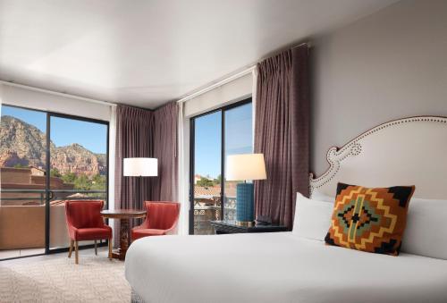 a hotel room with a bed and a large window at The Wilde Resort and Spa in Sedona