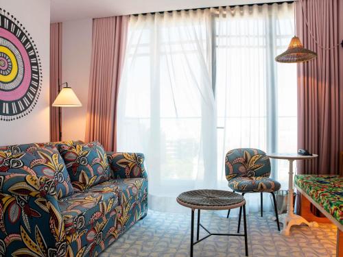 a living room with a couch and a chair at Mama Shelter Lisboa in Lisbon