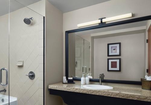a bathroom with a sink and a shower with a mirror at The Wilde Resort and Spa in Sedona