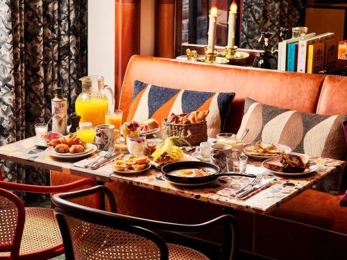 a breakfast table with food and drinks on it at Mama Shelter Lisboa in Lisbon