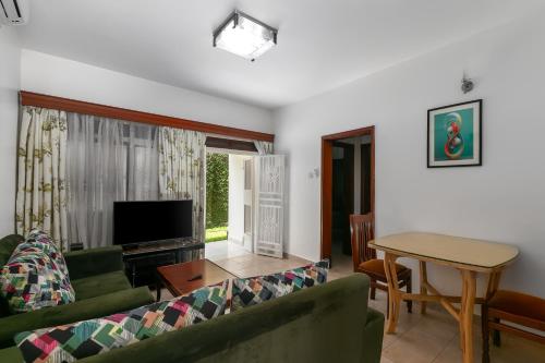 a living room with a couch and a table at Crane Serviced Apartments in Entebbe