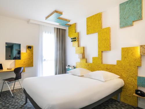 a bedroom with a white bed and a yellow wall at greet Hotel Rennes Pace in Pacé
