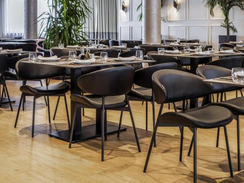 a row of tables and chairs in a restaurant at Mövenpick Hotel Lalez Durres in Durrës