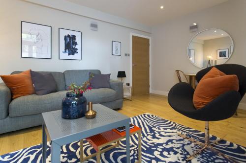 a living room with a couch and two chairs at Madison Hill - Byrne Garden 2 - One bedroom home in London