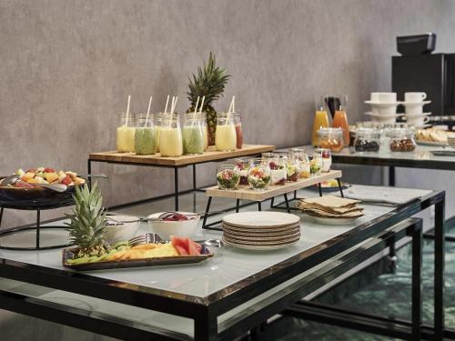 a buffet of food on a table with plates and drinks at Mercure Katowice Centrum in Katowice