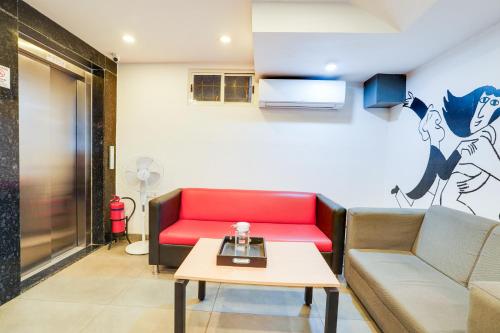 a living room with a couch and a table at Collection O BTM Layout Near Madiwala Lake Formerly Q Rooms in Bengaluru