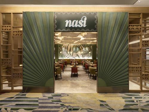 a restaurant with a dining room with tables and chairs at Swissôtel Clark Philippines in Clark