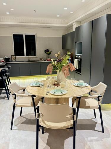 a kitchen and dining room with a table and chairs at Penta Square Executive Hotel Apartments City View DHA Lahore in Lahore
