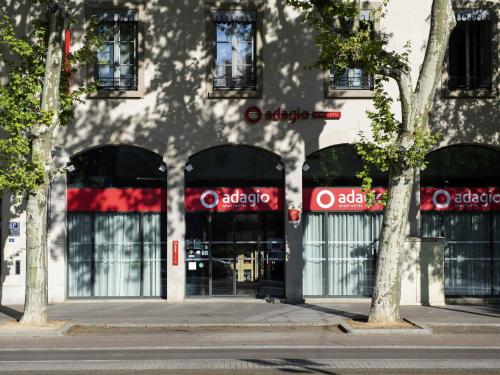 a building with a store front with windows at Aparthotel Adagio Lyon Patio Confluence in Lyon